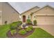 Well maintained home with a front lawn and garden at 32668 Abby Lax Ln, Wesley Chapel, FL 33543