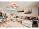 Spacious living room featuring a comfortable sectional sofa and open floor plan at 32668 Abby Lax Ln, Wesley Chapel, FL 33543