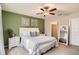 This bedroom features a ceiling fan and an ensuite bathroom entrance at 32668 Abby Lax Ln, Wesley Chapel, FL 33543