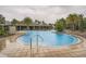 Community pool with lounge seating and covered pergola areas for relaxing at 32668 Abby Lax Ln, Wesley Chapel, FL 33543
