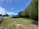Large backyard with an in-ground pool and a charming home with a white picket fence offers serene outdoor living at 37341 Rutledge Dr, Zephyrhills, FL 33541