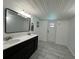Bright bathroom with a double sink vanity and plank tile flooring at 37341 Rutledge Dr, Zephyrhills, FL 33541