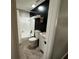 Modern bathroom with shower/tub combination and black accent wall, with decorative shelves at 37341 Rutledge Dr, Zephyrhills, FL 33541