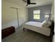 Bedroom with a window, closet, and a well-lit ceiling fan at 37341 Rutledge Dr, Zephyrhills, FL 33541