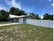 Well-maintained home exterior with attached garage and newly installed white fence providing security and curb appeal at 37341 Rutledge Dr, Zephyrhills, FL 33541