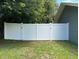 White vinyl fence provides privacy and security in this well-maintained backyard space at 37341 Rutledge Dr, Zephyrhills, FL 33541