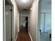 Hallway with hardwood floors and white walls leading to the various rooms in the home at 37341 Rutledge Dr, Zephyrhills, FL 33541
