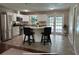 Modern kitchen with white cabinets, stainless steel appliances and french doors to backyard at 37341 Rutledge Dr, Zephyrhills, FL 33541