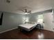 Comfortable main bedroom with ceiling fan, hardwood floors, and plenty of natural light at 37341 Rutledge Dr, Zephyrhills, FL 33541