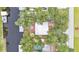 A beautiful aerial view of home surrounded by mature trees, a boat lift, a dock, and a pool at 9934 Peninsular Dr, Gibsonton, FL 33534