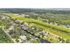 Expansive aerial shot showcasing a residential area with waterfront homes and community pool at 9934 Peninsular Dr, Gibsonton, FL 33534