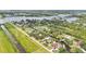 A captivating aerial view of a waterfront community with stunning canal access and mature trees at 9934 Peninsular Dr, Gibsonton, FL 33534