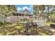 Large, fenced backyard, featuring a grill, perfect for barbecues and outdoor entertaining at 9934 Peninsular Dr, Gibsonton, FL 33534