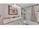 Bathroom with granite counters, decorative floors, and tiled shower/tub combo at 9934 Peninsular Dr, Gibsonton, FL 33534