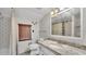 Well-lit bathroom features granite countertop vanity, with decorative tile, and a stylish shower-tub combination at 9934 Peninsular Dr, Gibsonton, FL 33534