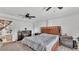 Bedroom featuring a dark fireplace, wood bedframe and bedside tables, with doorway access to another room at 9934 Peninsular Dr, Gibsonton, FL 33534