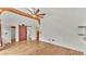 Spacious bedroom with vaulted ceilings, hardwood floors, barn door closet, and ensuite bathroom at 9934 Peninsular Dr, Gibsonton, FL 33534