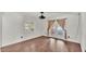 Bedroom with wood floors, a window, and a door that leads to the outdoors at 9934 Peninsular Dr, Gibsonton, FL 33534