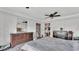 Bedroom with wooden floors, white walls, bed, dresser, doors, and decorative fireplace at 9934 Peninsular Dr, Gibsonton, FL 33534