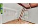 Bedroom features hardwood floors, closet, and unique ceiling with ladder access at 9934 Peninsular Dr, Gibsonton, FL 33534