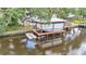 Boat lift and waterfront dock overlooking river surrounded by beautiful, mature trees at 9934 Peninsular Dr, Gibsonton, FL 33534