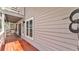 Exterior view showing a wooden deck running the length of the home with access to a set of double doors at 9934 Peninsular Dr, Gibsonton, FL 33534