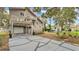 Multi-story home with balconies and access to a garage and driveway featuring geometric concrete blocks at 9934 Peninsular Dr, Gibsonton, FL 33534