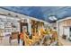 Cluttered garage space with a motorcycle, storage containers, furniture, and tools with a blue tarp on ceiling at 9934 Peninsular Dr, Gibsonton, FL 33534