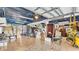 Garage with tiled floors, storage boxes, various tools and equipment, and a blue tarp on the ceiling at 9934 Peninsular Dr, Gibsonton, FL 33534