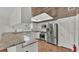 Modern kitchen with granite countertops, stainless steel appliances, and wood floors at 9934 Peninsular Dr, Gibsonton, FL 33534