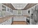 Updated kitchen with white cabinets, granite countertops, and stainless steel appliances at 9934 Peninsular Dr, Gibsonton, FL 33534