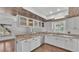 Updated kitchen with white cabinets, granite counters, and stainless steel appliances at 9934 Peninsular Dr, Gibsonton, FL 33534