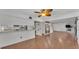 Open concept living room and kitchen with wood floors and a breakfast bar at 9934 Peninsular Dr, Gibsonton, FL 33534