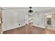 Open-concept living room showcases hardwood floors and seamless transitions to kitchen and bathroom at 9934 Peninsular Dr, Gibsonton, FL 33534