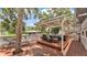 Expansive wooden deck featuring a pergola and cozy outdoor seating at 9934 Peninsular Dr, Gibsonton, FL 33534