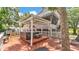 Expansive wooden deck featuring a pergola and cozy outdoor seating at 9934 Peninsular Dr, Gibsonton, FL 33534