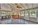 Covered outdoor patio featuring an outdoor kitchen, ceiling fans, and bar at 9934 Peninsular Dr, Gibsonton, FL 33534