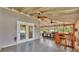 Covered outdoor patio featuring an outdoor kitchen, ceiling fans, and bar at 9934 Peninsular Dr, Gibsonton, FL 33534