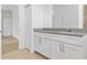 Updated bathroom with a double sink, modern vanity, and neutral tile floors at 3157 Bay City Ter, North Port, FL 34286