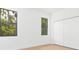 Bright bedroom with wood floors, two windows, and double-door closet at 3157 Bay City Ter, North Port, FL 34286