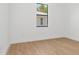 Bright, airy bedroom with wood floors and a large window at 3157 Bay City Ter, North Port, FL 34286