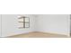 Clean bedroom with a window, neutral walls, light-colored wood floor, and modern trim and baseboards at 3157 Bay City Ter, North Port, FL 34286