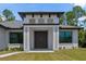 Close up of the elegant front entrance with double doors, modern design elements, and well-maintained landscaping at 3157 Bay City Ter, North Port, FL 34286