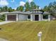 Charming one-story home with a two-car garage, stylish front entrance, and well-kept lawn for a welcoming curb appeal at 3157 Bay City Ter, North Port, FL 34286