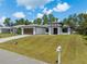 Charming home with a well-manicured lawn, long driveway, and a two-car garage, highlighting suburban living at 3157 Bay City Ter, North Port, FL 34286