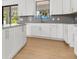 Modern kitchen featuring white cabinets, gray countertops, and an island, creating a clean and functional space at 3157 Bay City Ter, North Port, FL 34286