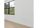 Minimalist room featuring a large window with an expansive view of trees and sky at 3157 Bay City Ter, North Port, FL 34286
