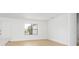 Bright, minimalist living space with a large window, neutral walls, and light wood flooring for a modern feel at 3157 Bay City Ter, North Port, FL 34286