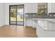 Modern kitchen with white cabinets, gray counters and island at 3157 Bay City Ter, North Port, FL 34286