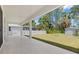 Covered patio overlooking a fenced backyard and lush greenery at 3157 Bay City Ter, North Port, FL 34286